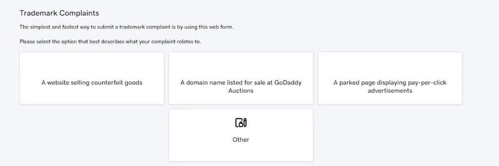 A step in the GoDaddy trademark complaint form where users must select the type of complaint. Options include "A website selling counterfeit goods," "A domain name listed for sale at GoDaddy Auctions," "A parked page displaying pay-per-click advertisements," and "Other."